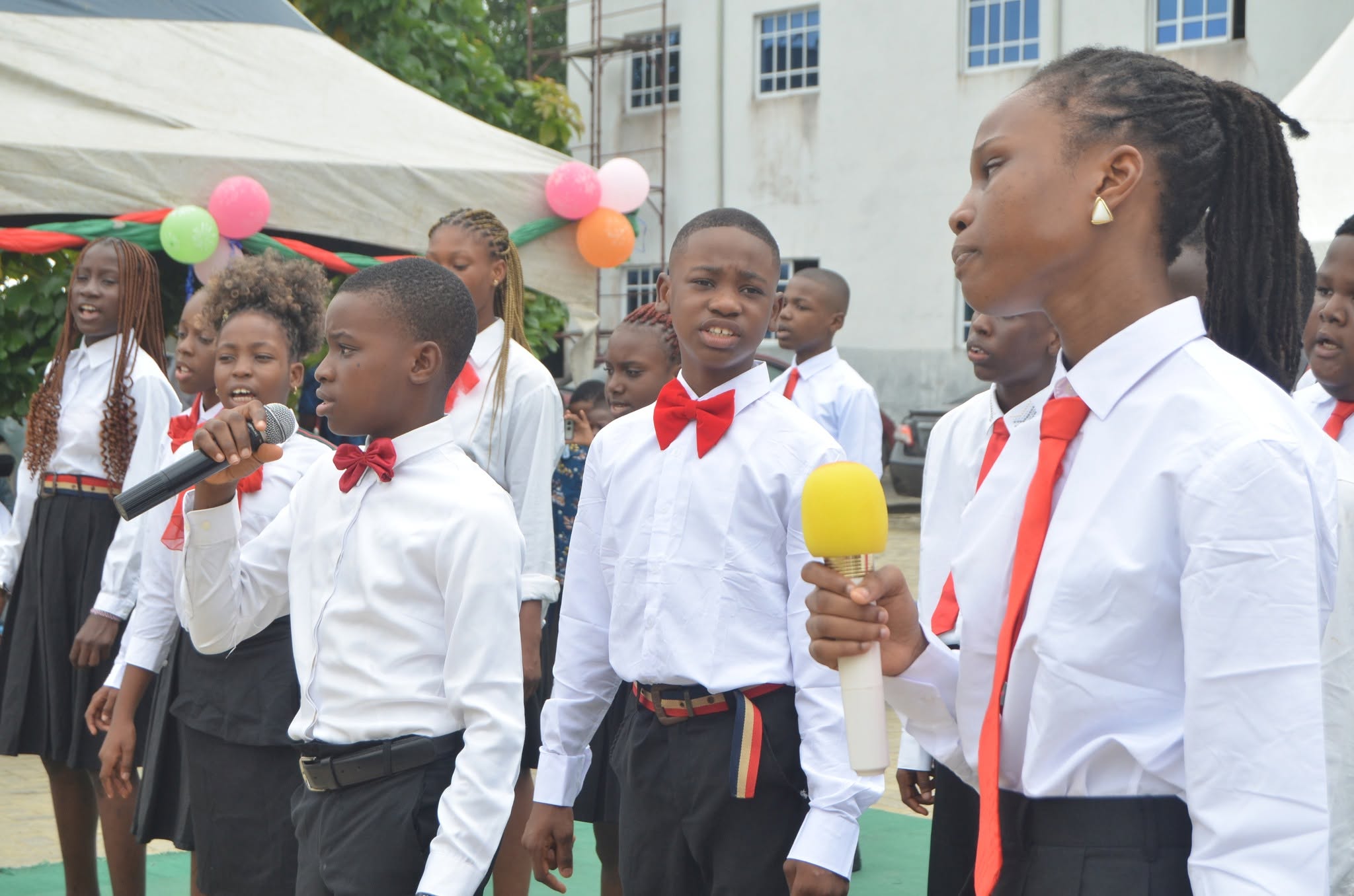 BOBAES pupils singing during an outdoor school assembly